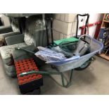 A wheelbarrow and gardening items