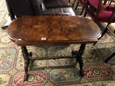 A walnut side table with stretcher base