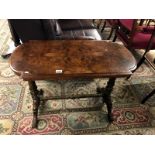 A walnut side table with stretcher base