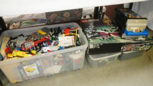 A large box of lego with some partially complete kits,