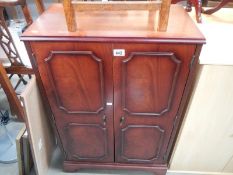 A darkwood stained TV/stereo cabinet