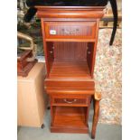 A pair of darkwood stained bedside cabinets