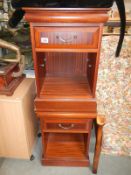 A pair of darkwood stained bedside cabinets