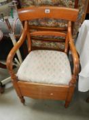 An Edwardian mahogany carver chair commode