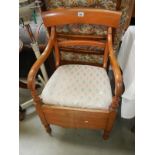 An Edwardian mahogany carver chair commode