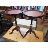 A pair of tripod wine tables with leather inset