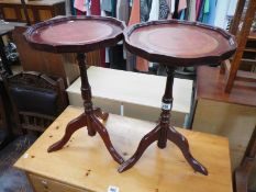 A pair of tripod wine tables with leather inset