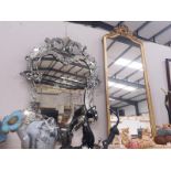 A gilt framed mirror and a venetian style mirror framed mirror