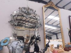 A gilt framed mirror and a venetian style mirror framed mirror