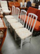 A set of 4 white painted dining chairs