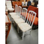 A set of 4 white painted dining chairs