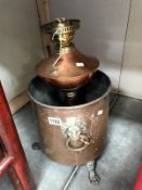 A copper coal bin and a copper oil lamp base