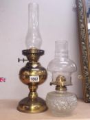 A brass oil lamp and a glass oil lamp