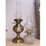 A brass oil lamp and a glass oil lamp