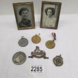 A small quantity of medal etc and 2 old framed photographs.