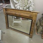 A gilt framed over mantel mirror.