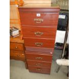 A pair of mahogany effect bedside chest of drawers with glass tops