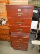 A pair of mahogany effect bedside chest of drawers with glass tops