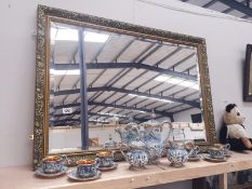 A large gilt framed bevel edged mirror