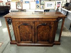 An Edwardian mahogany side board with mirror panels