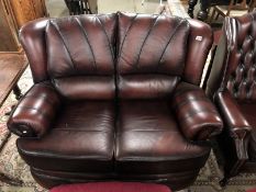 An oxblood 2 seater sofa