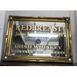 A gilt framed bevel edge mirror with advertising for redbreast John Jameson & Son's single pot
