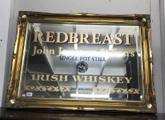 A gilt framed bevel edge mirror with advertising for redbreast John Jameson & Son's single pot