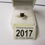 A square cut garnet gents 9ct gold ring.