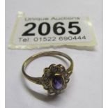 A 9ct gold ring set amethyst and white stones, size O.
