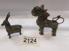 A Chinese dragon perfume bottle and a small Chinese antelope.