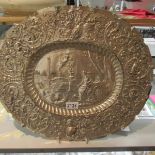 A large silver plated oval tray depicting a garden scene with scroll surround.