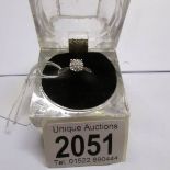 A white gold diamond cluster ring, size O Half.