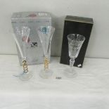 A boxed engraved silver jubilee wine glass and a boxed pair of millenium wine glasses.
