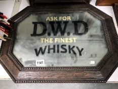 An oak framed mirror advertising D.W.