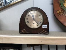 An arch wooden mantel clock