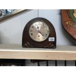 An arch wooden mantel clock