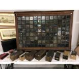 A collection of glass slides and slides display cabinet
