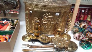 A brass log bin with other brassware including candlesticks, trivet,