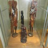 4 carved wood figures.