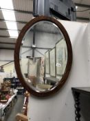 An oak oval bevel edged mirror