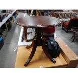 A darkwood stained tripod side table