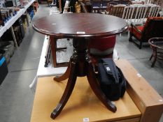 A darkwood stained tripod side table