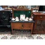 A marble top satin walnut washstand with green tile back