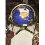 A decorative globe on brass stand