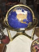 A decorative globe on brass stand