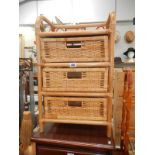 A cane/wicker bathroom chest of drawers