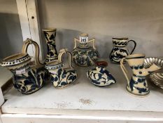 7 items of blue and white motto ware including jugs,