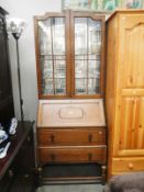 A 1930s oak glazed top bureau book case