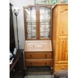 A 1930s oak glazed top bureau book case