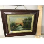 A framed and glazed oil painting of bridge over river,